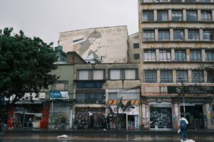 Buildings and storefronts line a city street.