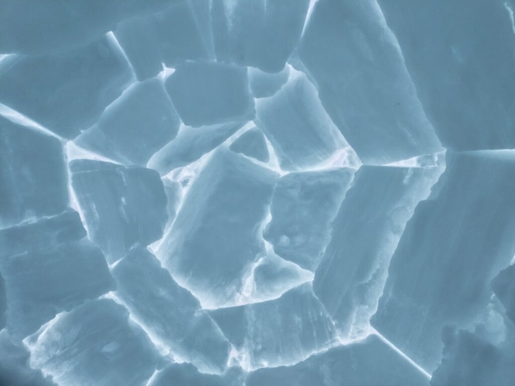 a close up view of ice cubes in the snow